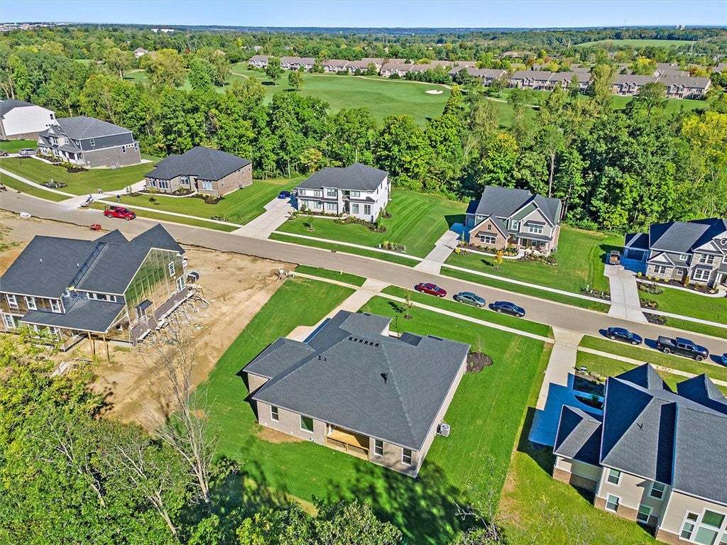 A quiet neighborhood street winds past modern home