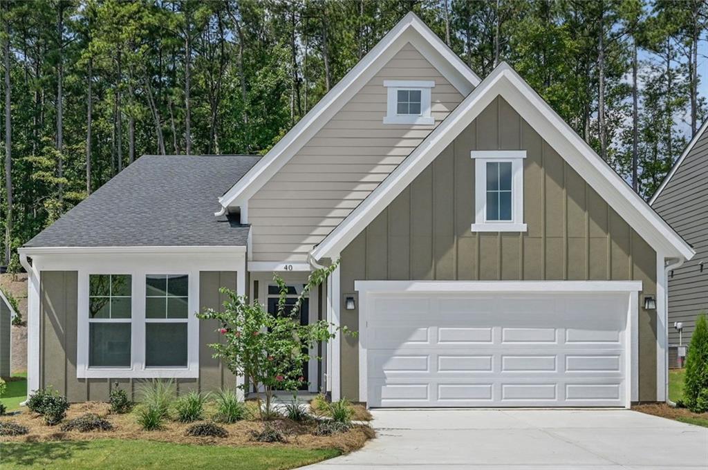 Contemporary craftsman-style residence featuring a dark gray vertical siding gable with white trim