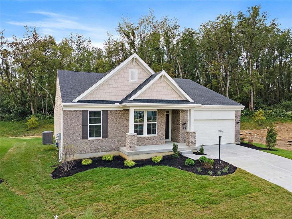 A classic brick facade and manicured lawn create e