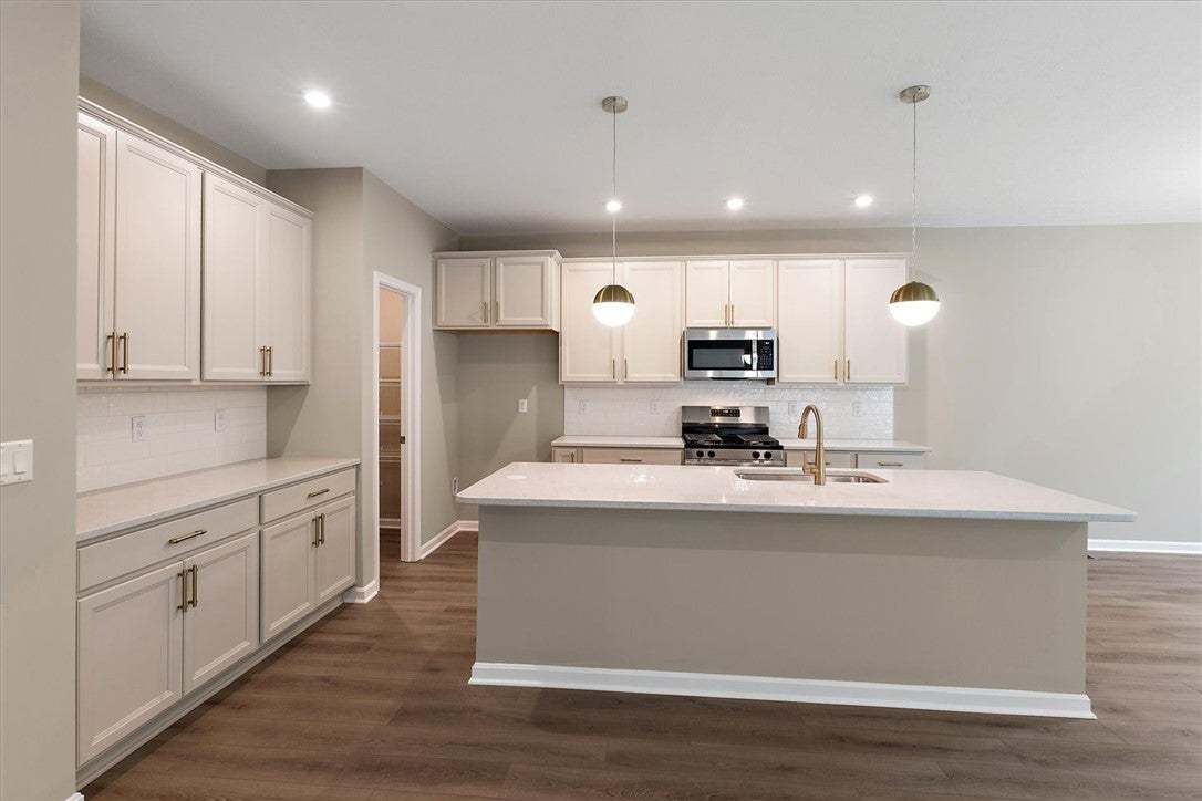 Rich wood floors anchor this contemporary kitchen