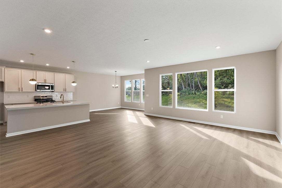 Sunlight streams across the wood floors of an airy