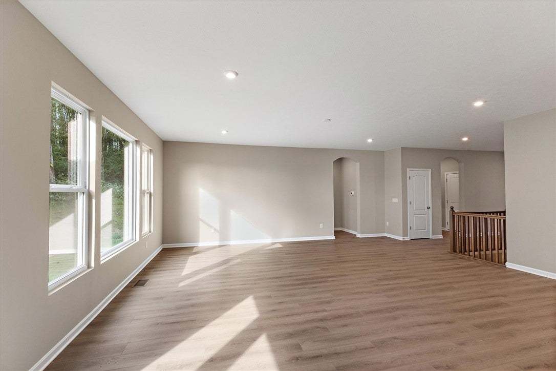 Natural light pours across the wood floors of this