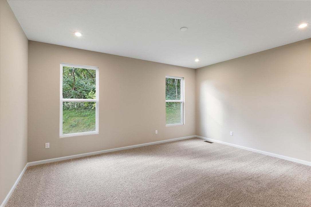 Plush carpeting and recessed lighting create a com
