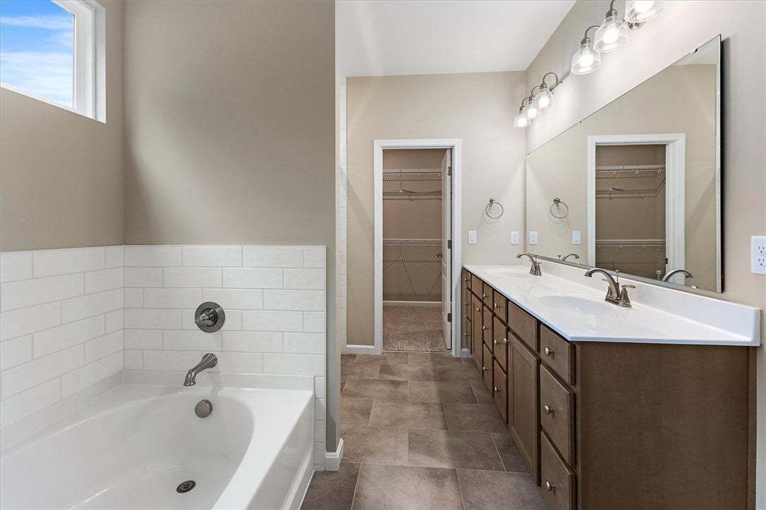 Tile floors and a soaking tub define this bathroom
