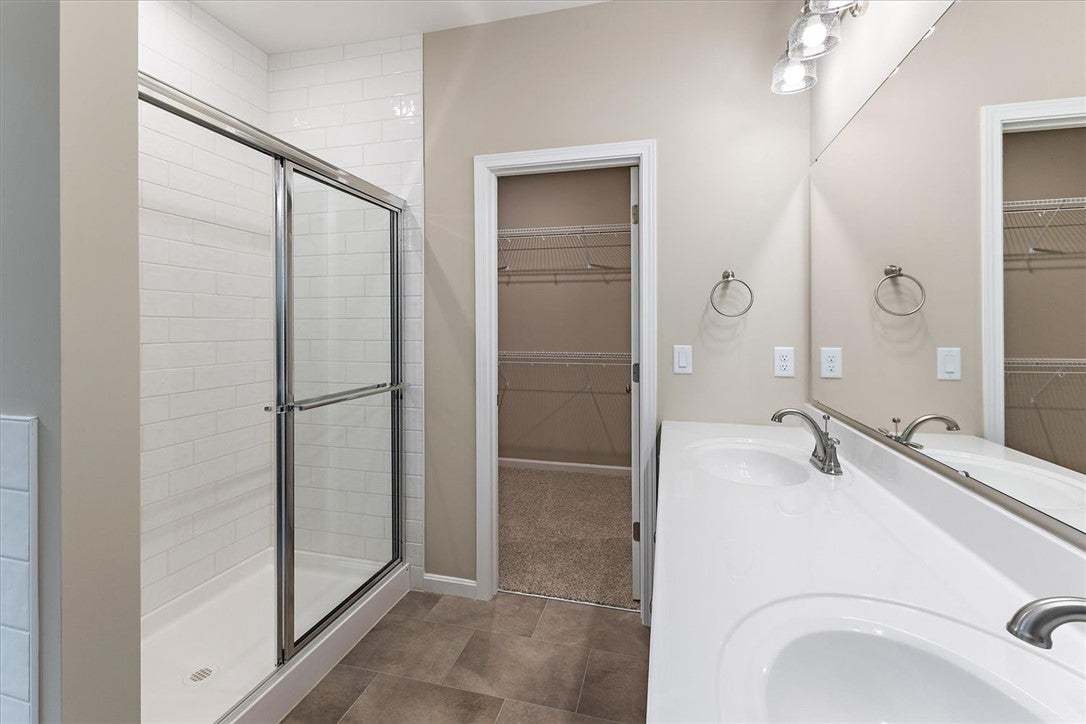 Clean lines and a spacious dual vanity define this