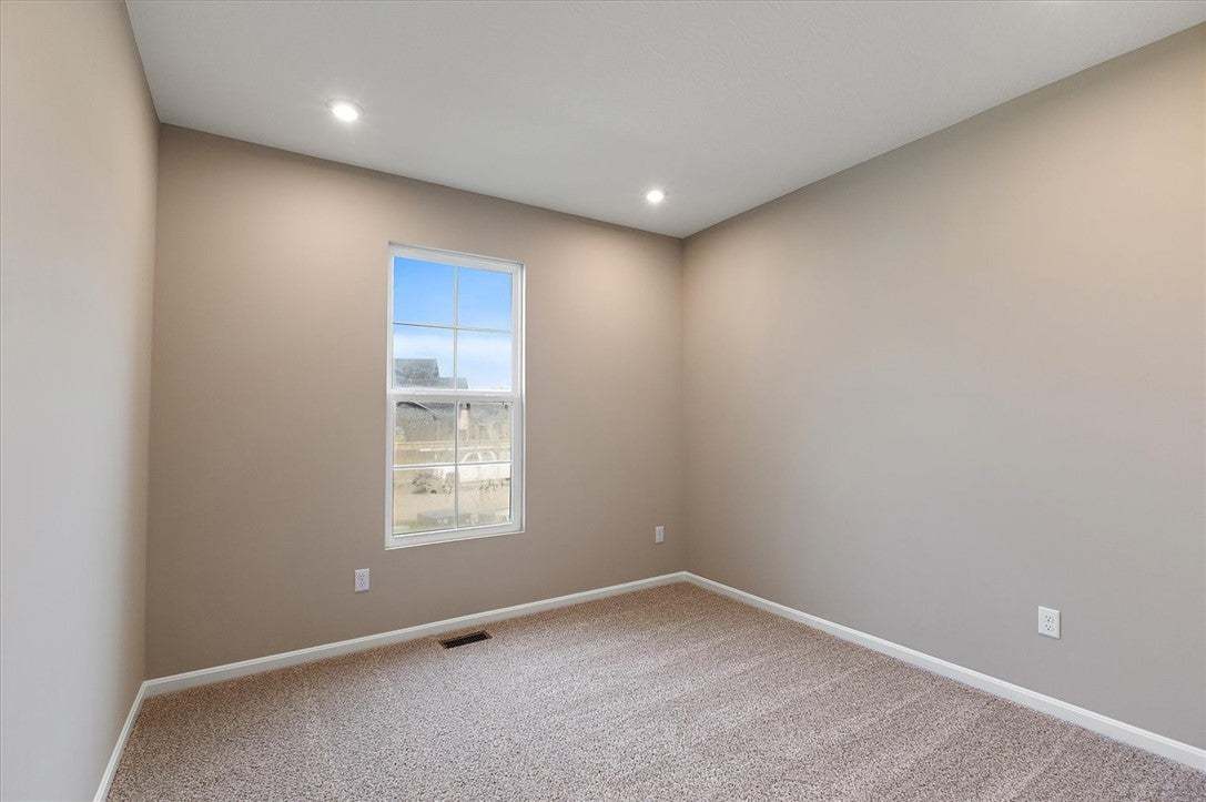 Recessed lighting and soft carpeting create a comf