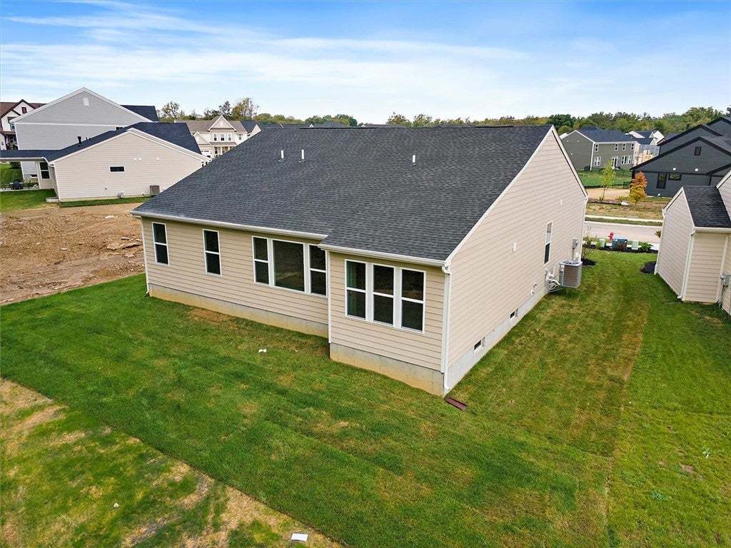 A well-maintained lawn surrounds the rear facade o