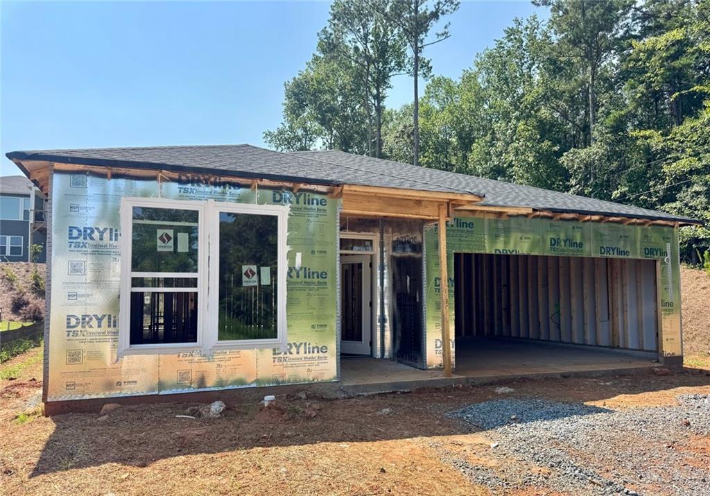 Single-story construction with attached garage, asphalt shingle roofing, and new windows