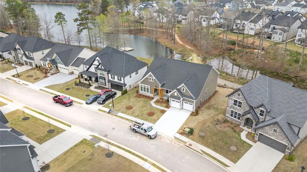 Aerial perspective of suburban area with a nearby body of water