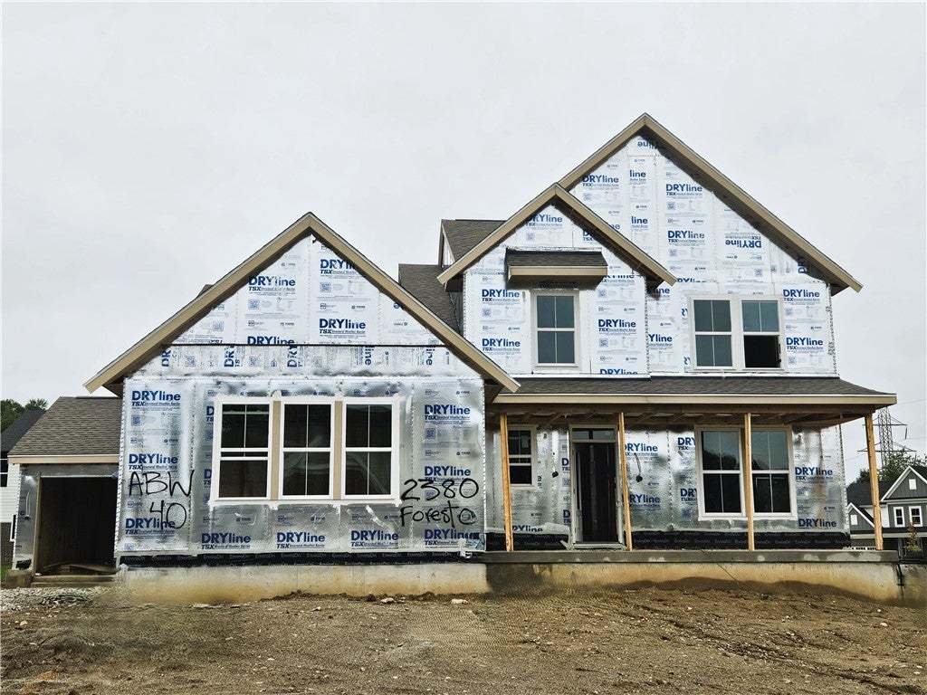 Multi-gable rooflines and a deep front porch defin