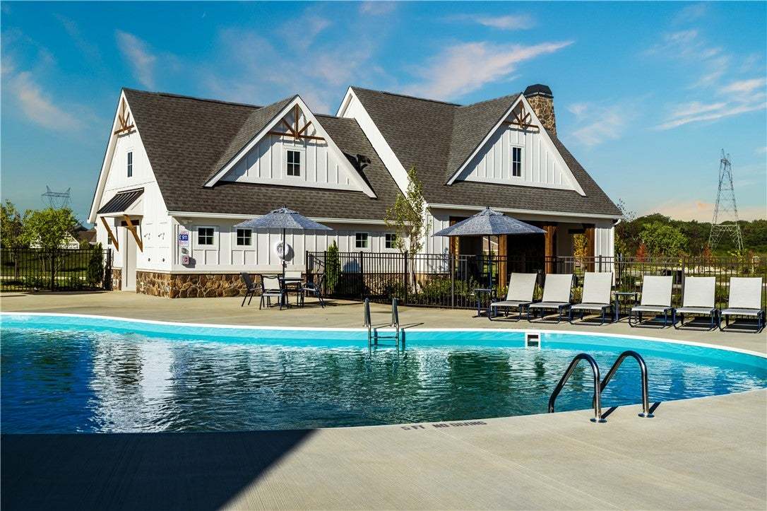 A sparkling community pool sits alongside a beauti
