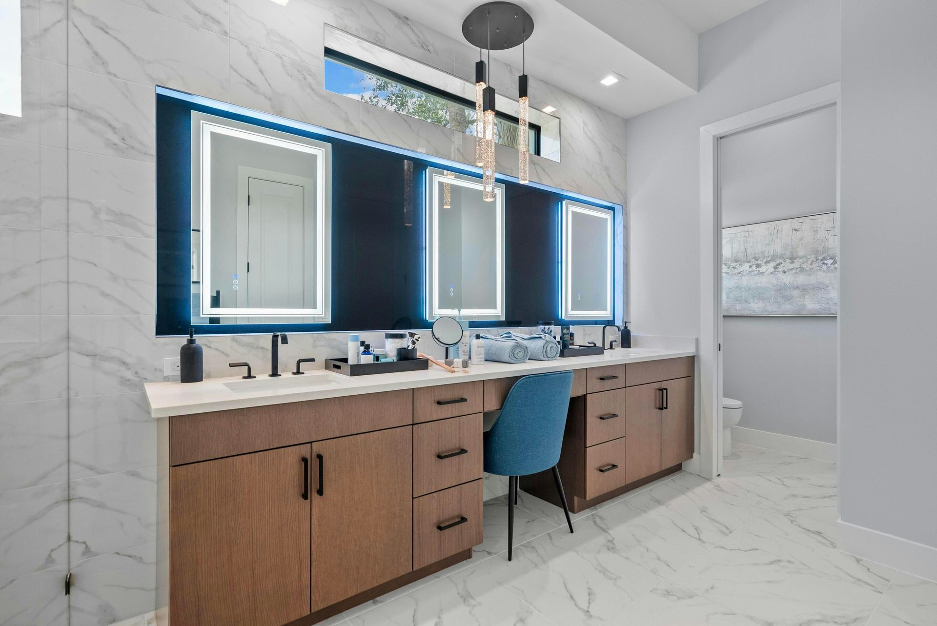 Master bath with blue accents, flat cabinets and matte large tile floor