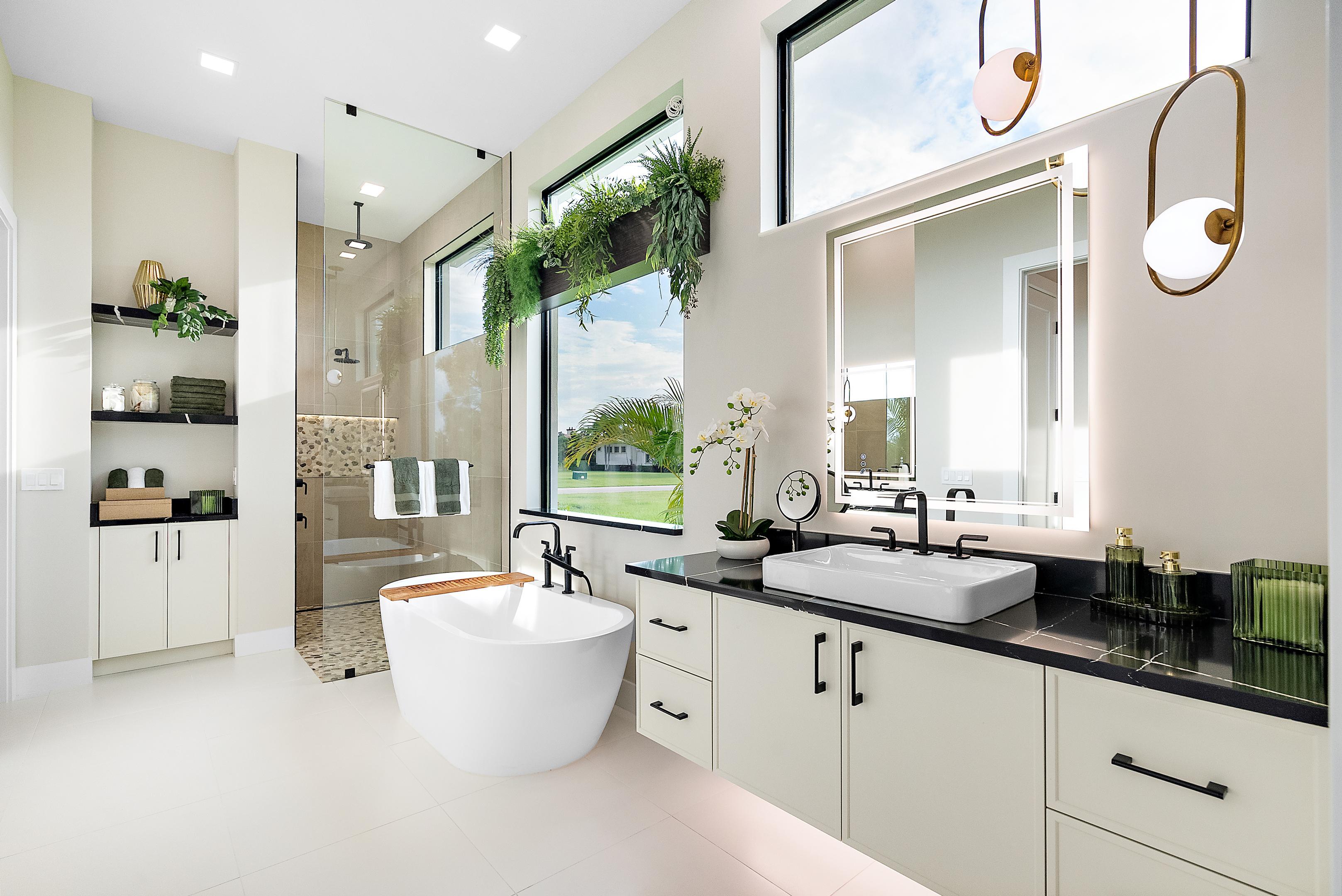 Master bath with modern floating cabinets, soaker tub and talk-in shower