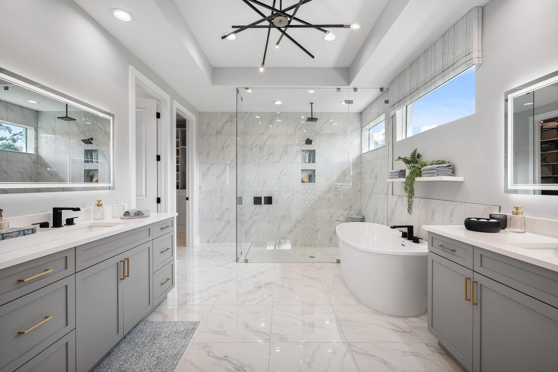 Master bath with porcelain tile on floor and in shower, LED mirrors and ovel modern soaker tub