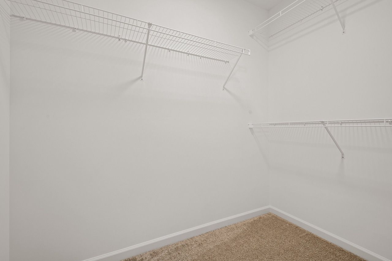 Walk in closet in the Ariel model from Garman Builders