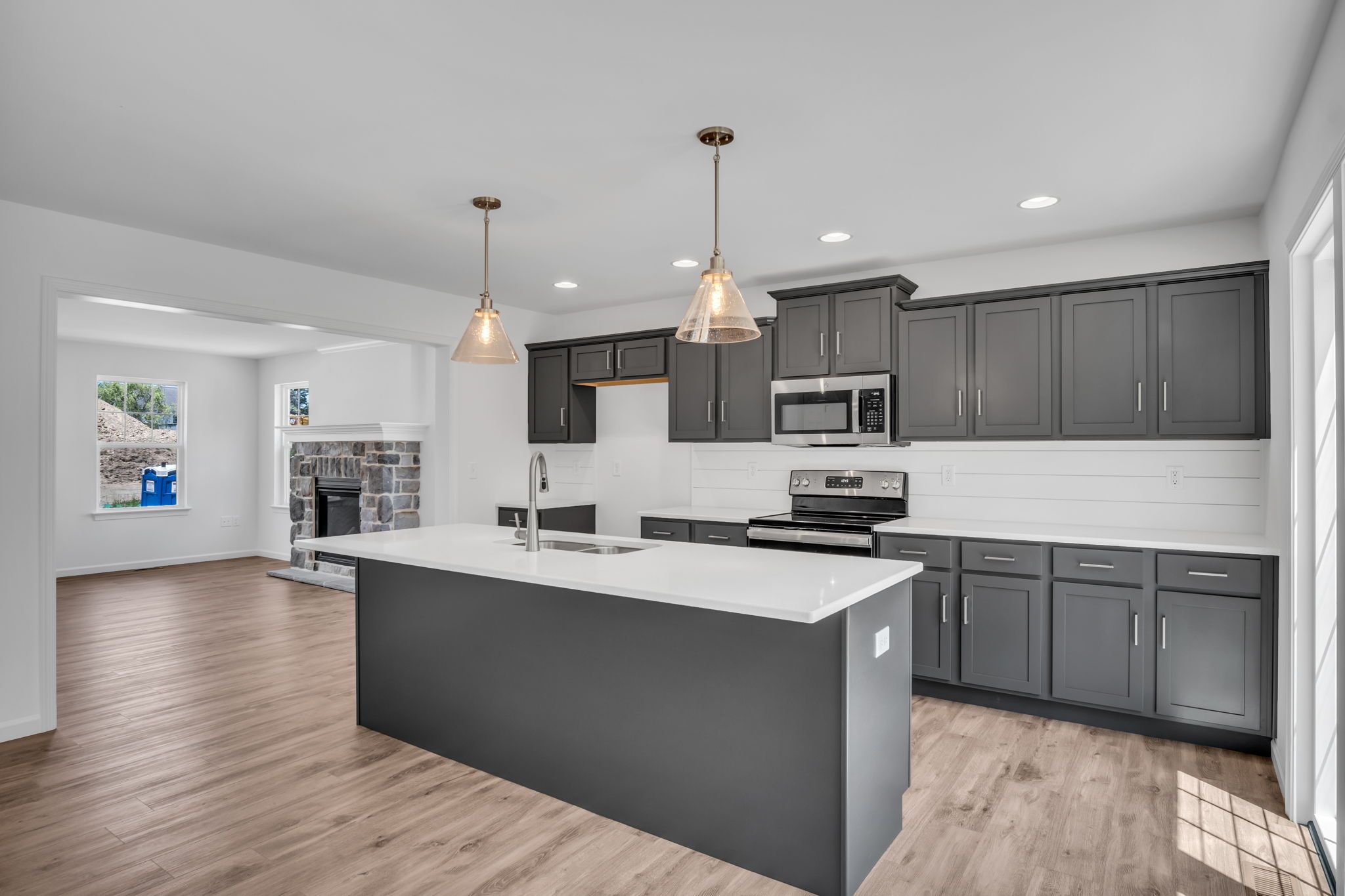 Kitchen with center island of the Charlotte Model from Garman Builders