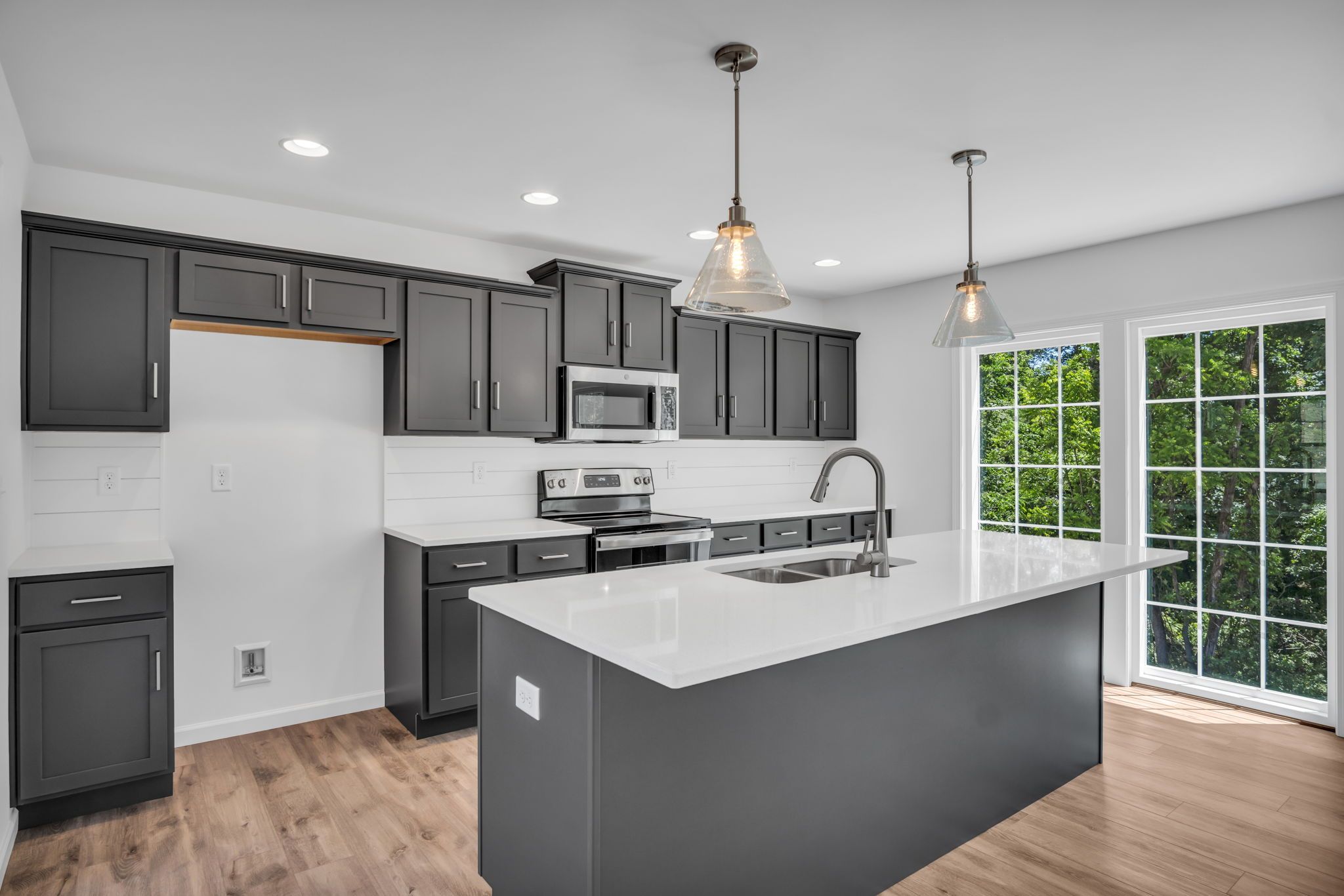 Kitchen with center island of the Charlotte Model from Garman Builders