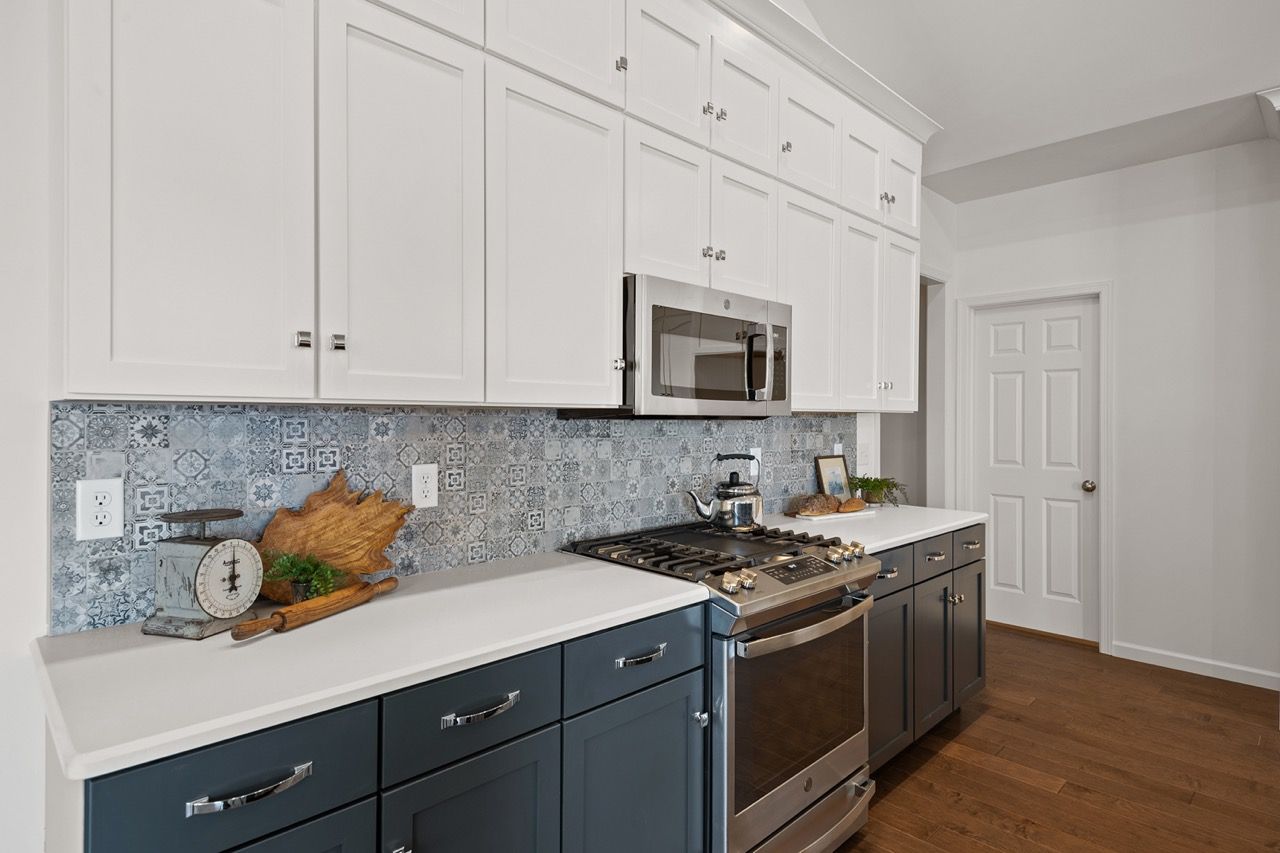 Kitchen with white cabinets of the Blakely model from Garman Builders