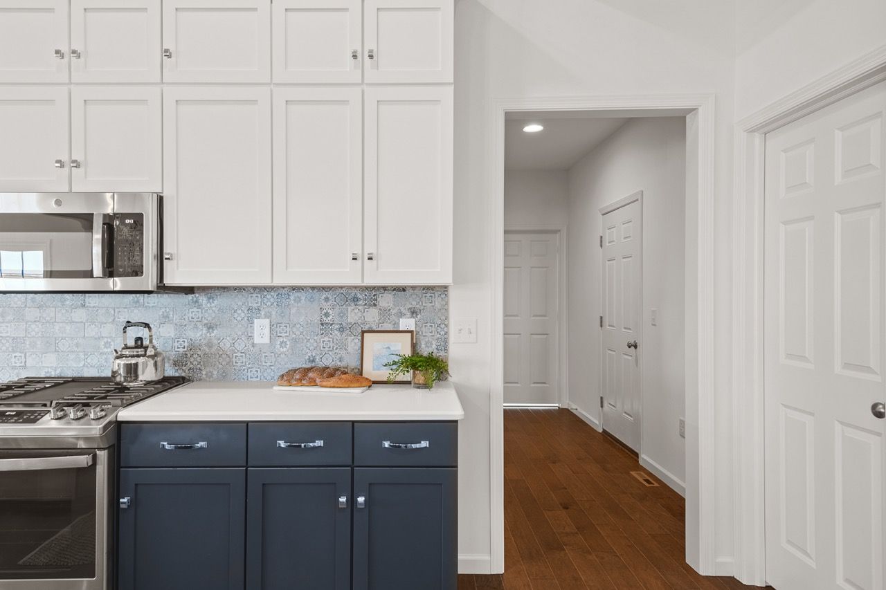 Kitchen with white cabinets of the Blakely model from Garman Builders