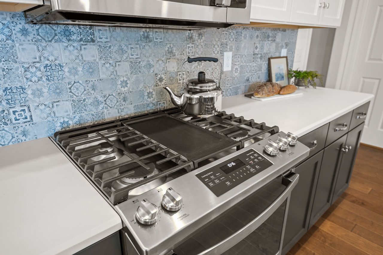 Kitchen with white cabinets of the Blakely model from Garman Builders