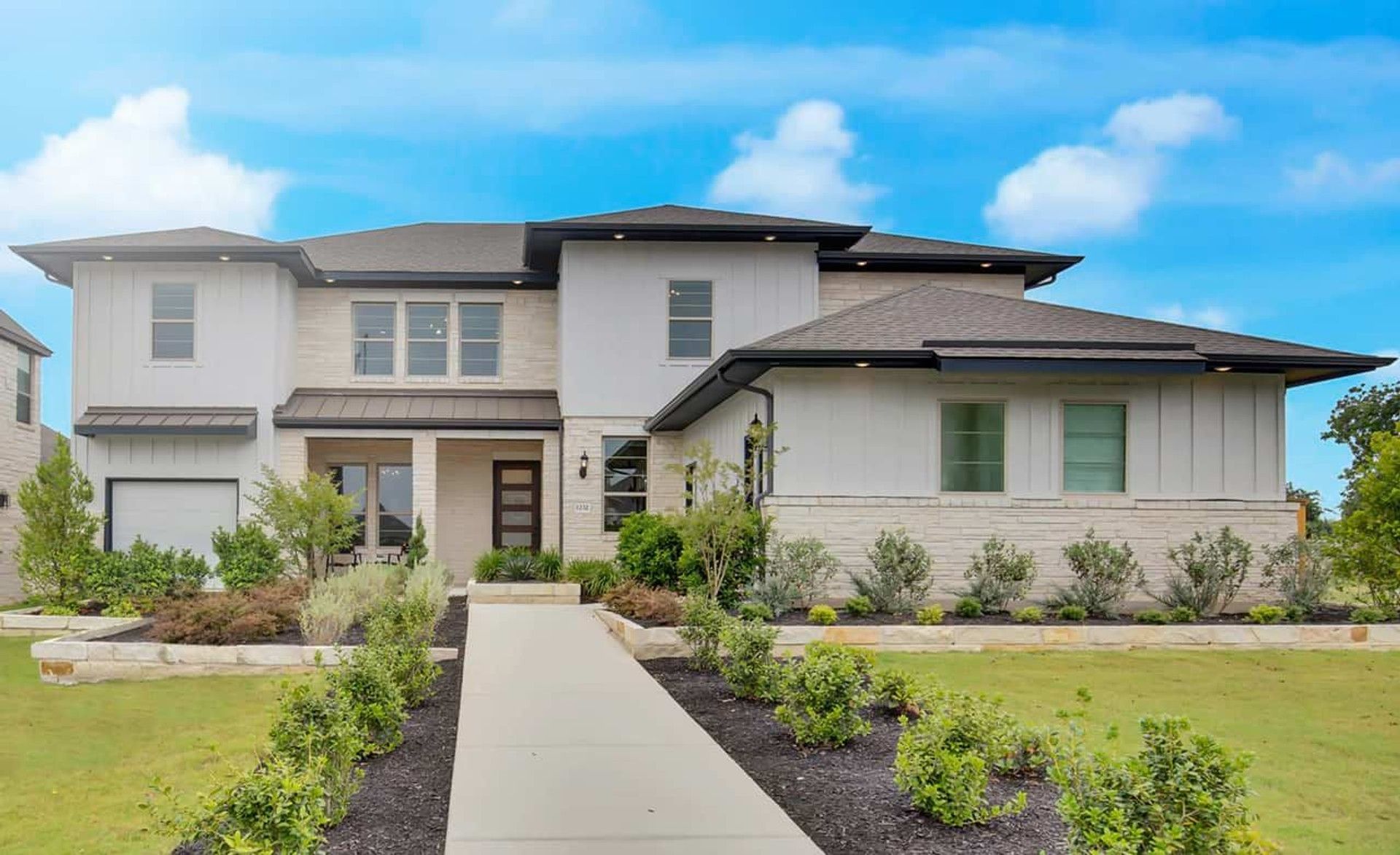Stunning modern design with exquisite stone facade and expansive windows in Oaks at San Gabriel.