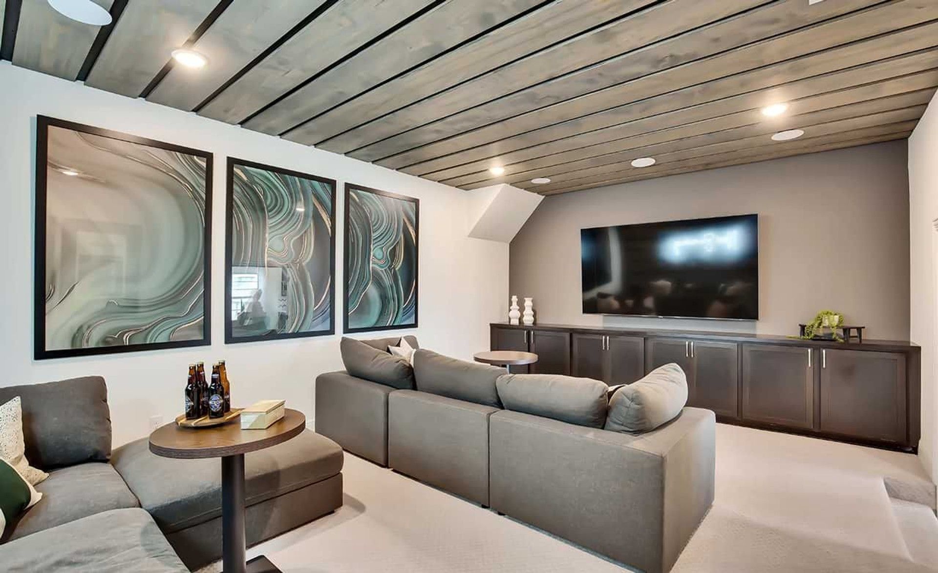 Sophisticated media room with modern wood ceiling and sleek built-ins. Oaks at San Gabriel, Texas.