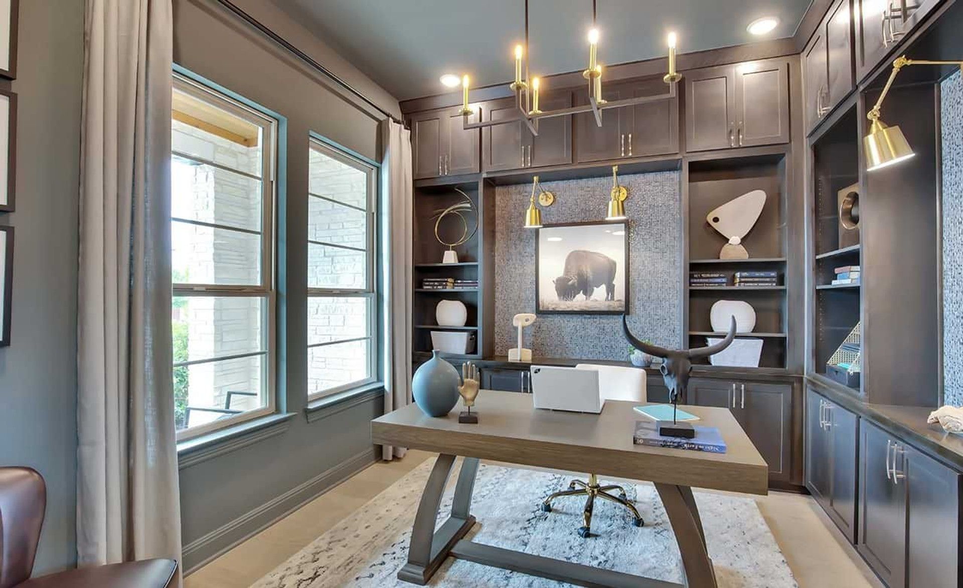 This Oaks at San Gabriel home office features bespoke cabinetry and sleek modern fixtures, embodying luxury.