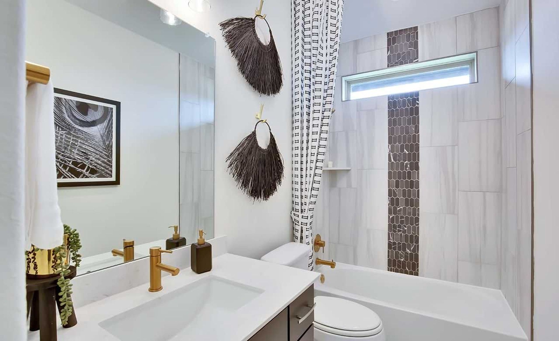 Marble tiles and gold fixtures elevate this Oaks at San Gabriel bathroom's luxurious ambiance.