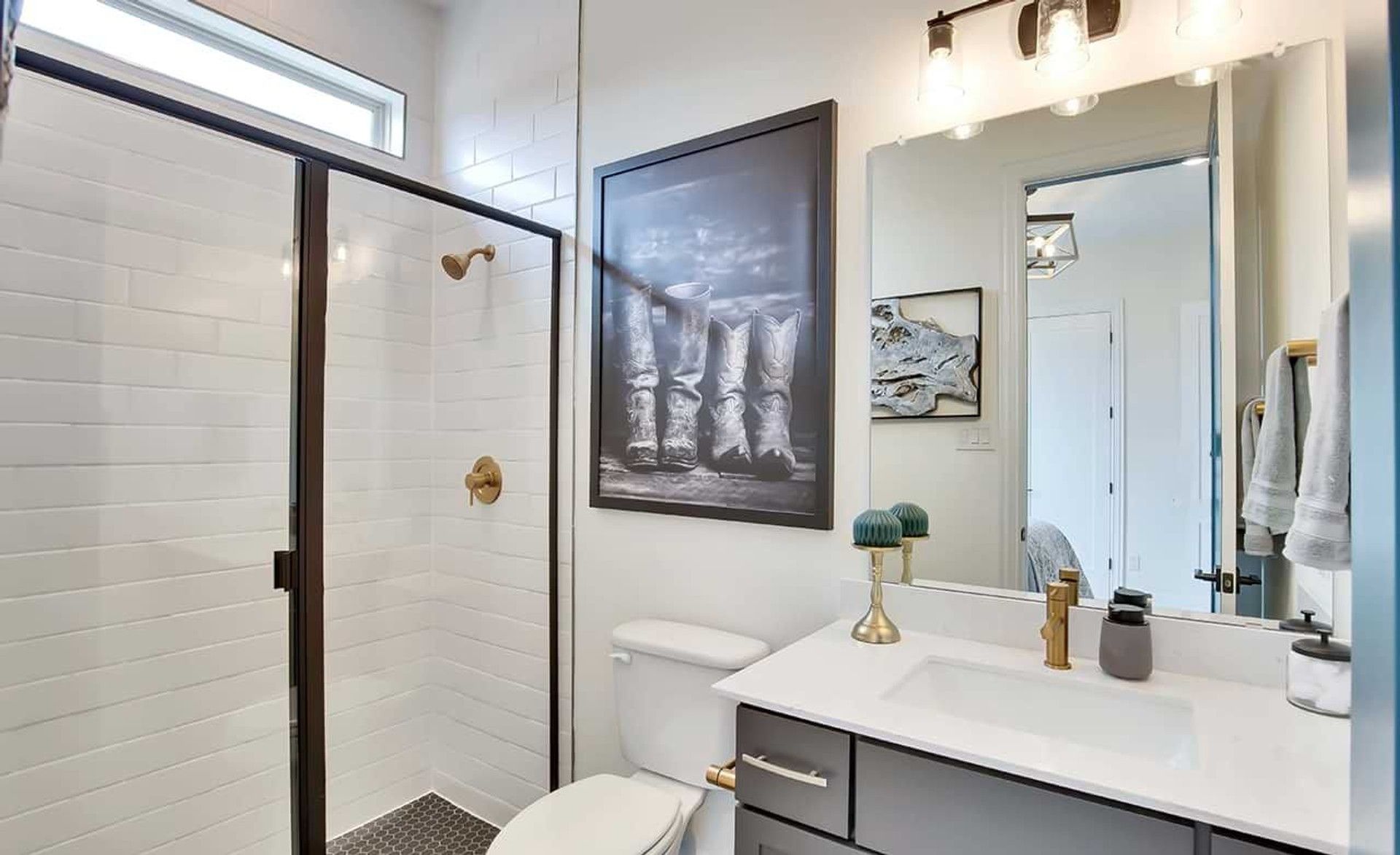 Experience luxury with this glass-enclosed shower and gold fixtures in Oaks at San Gabriel.
