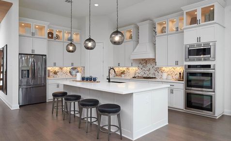 Elegantly crafted kitchen with high-end appliances, marble island, in Anthem community.