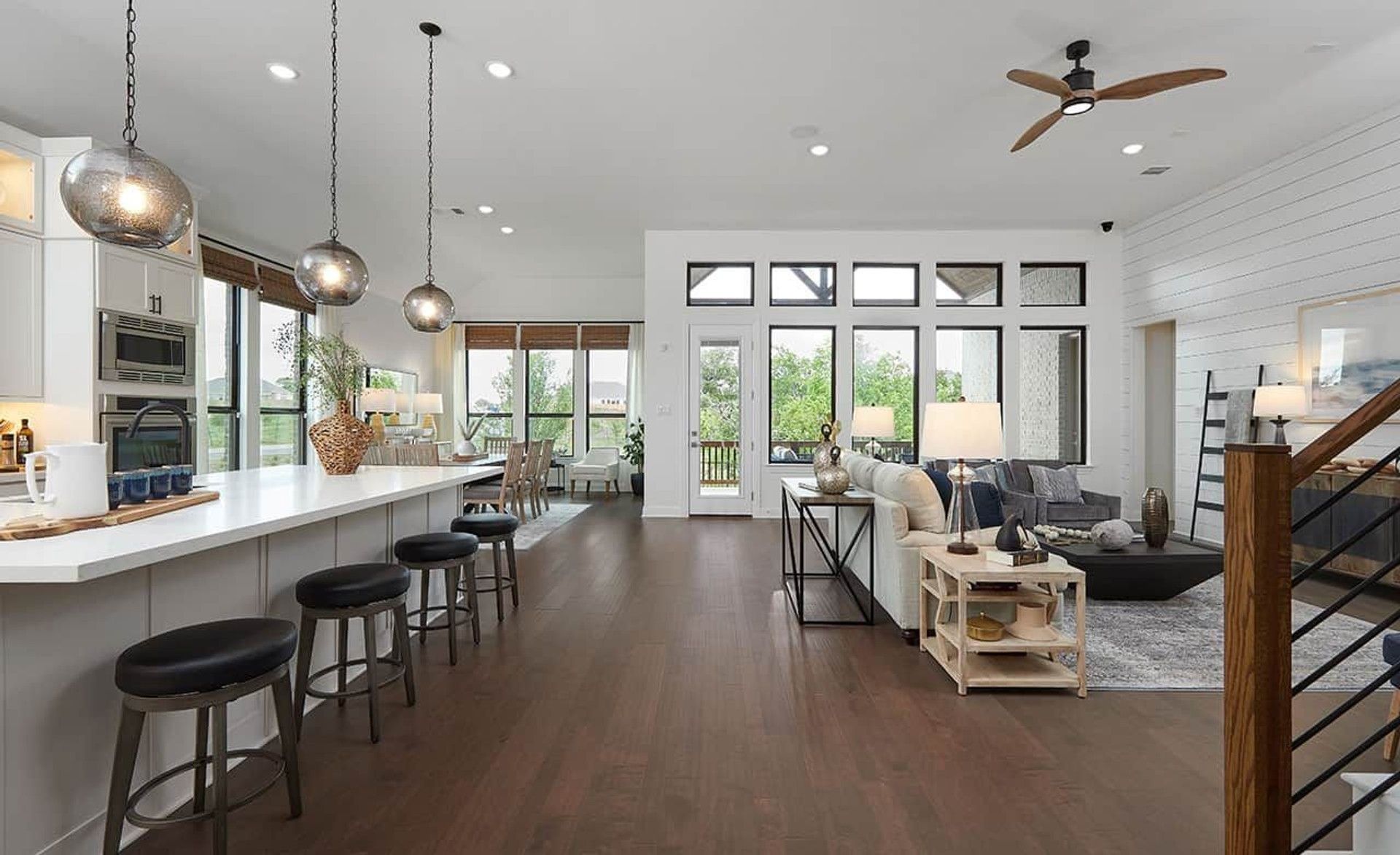 Expansive wood flooring, sleek modern lighting, and floor-to-ceiling windows in Anthem, AZ.