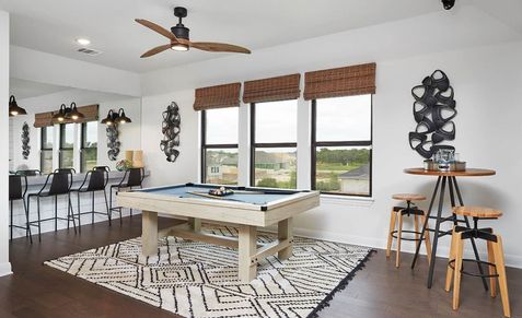 Sleek game room with pool table, chic bar seating, and large windows in the upscale Anthem community.