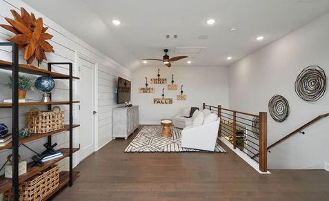 Luxurious loft with elegant wooden flooring, sleek shiplap walls, and exquisite decor. Anthem, Texas.