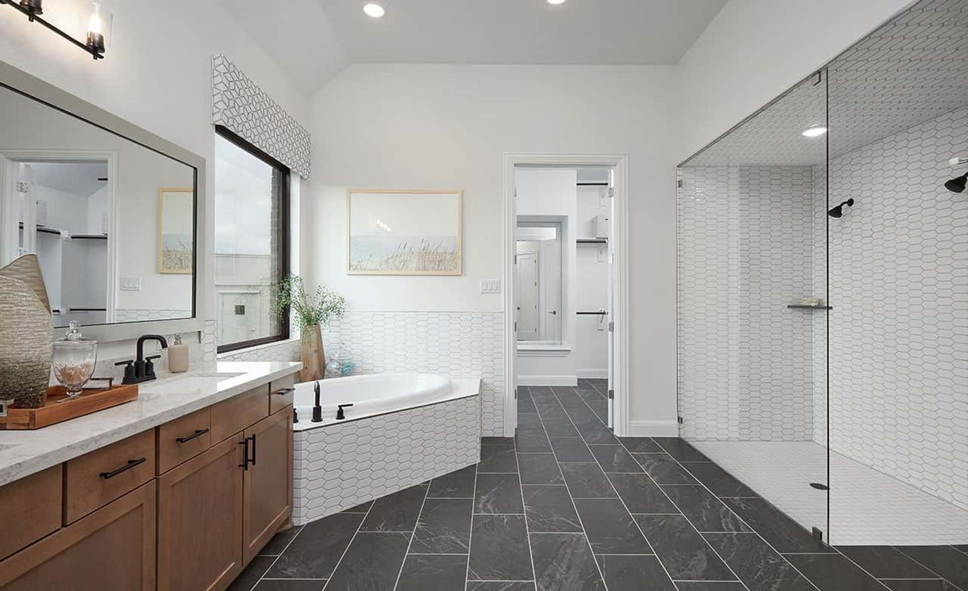 Experience luxury with a sleek shower, elegant tiles, and modern bathtub in Anthem's distinguished community.