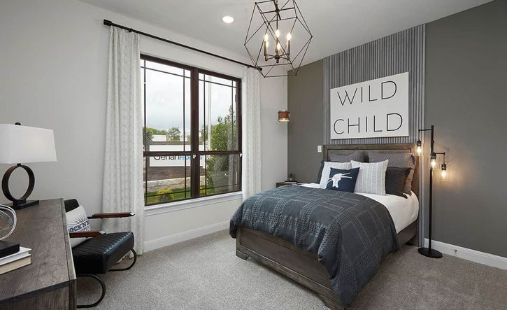 Experience sophisticated comfort in Anthem with this chic bedroom's geometric lighting and stylish decor.