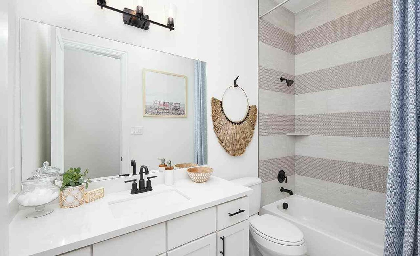 Sophisticated bathroom with matte black fixtures and striped tile design in Anthem, showcasing refined architectural elegance.