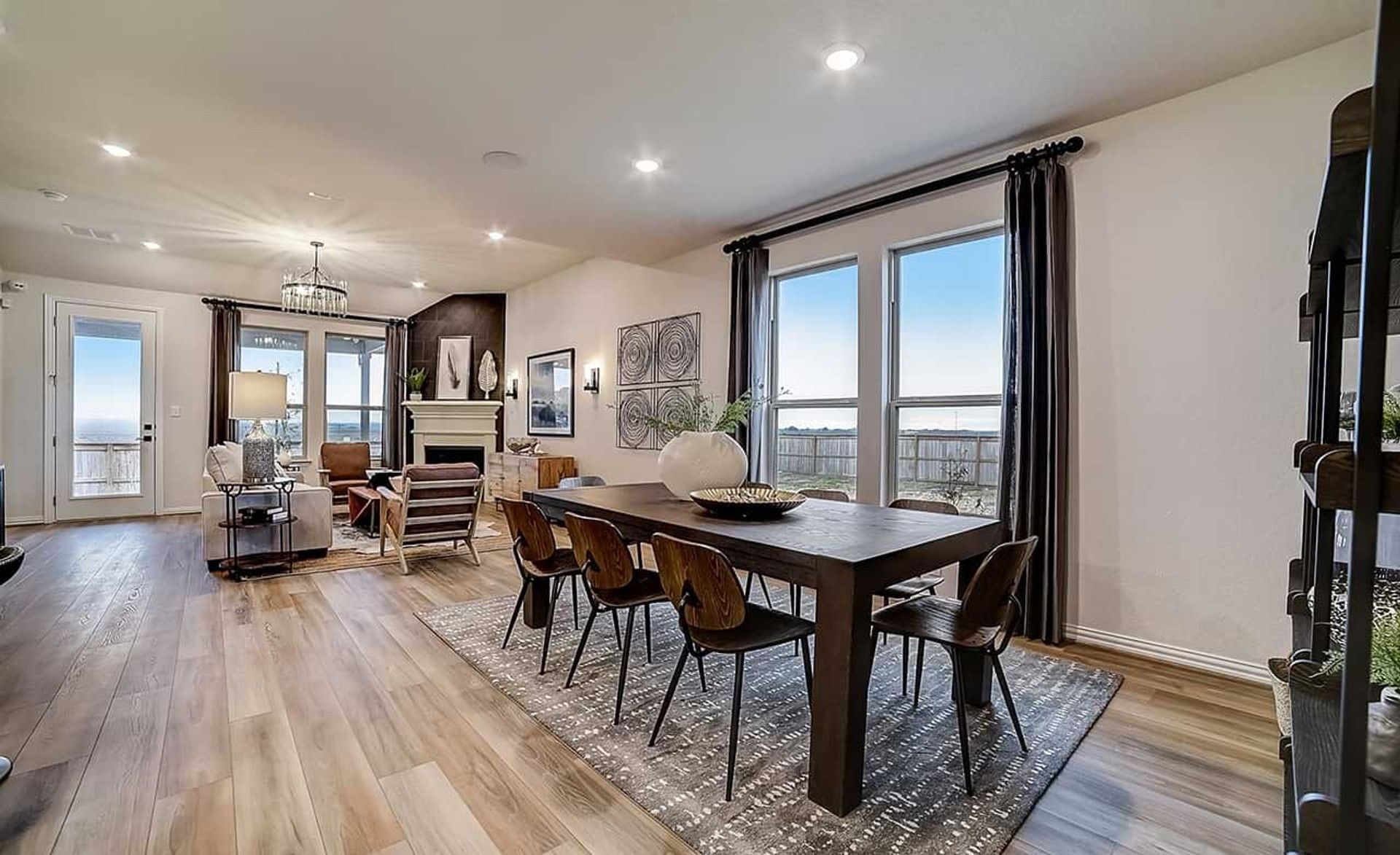 Spacious elegance with hardwood floors, chic fireplace, and expansive windows in Dauer Ranch, Texas.