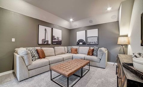 Dauer Ranch living room boasts a plush sectional, chic wall art, and sophisticated lighting accents.