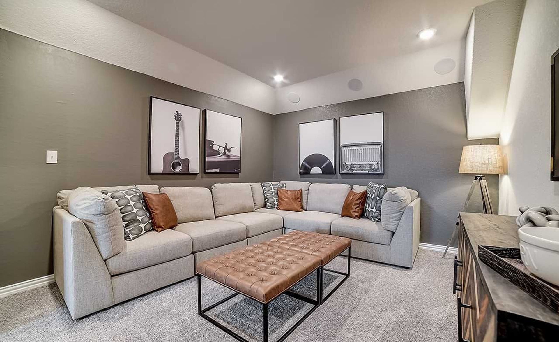 Dauer Ranch living room boasts a plush sectional, chic wall art, and sophisticated lighting accents.