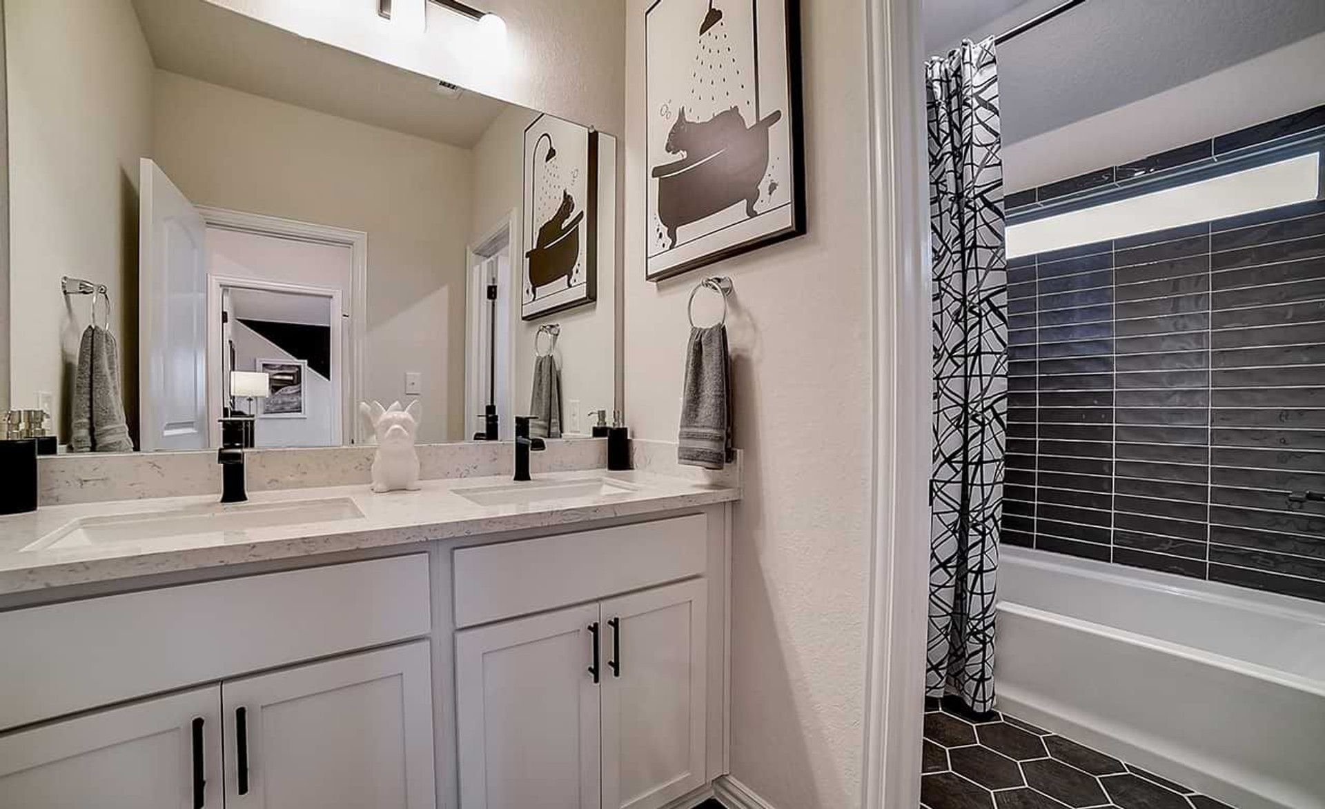 Elegant dual sinks, premium marble surfaces, and chic hexagonal tiles enhance this Dauer Ranch bathroom.