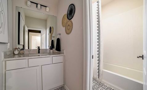 Experience refined elegance with intricate tile work and sleek finishes in Dauer Ranch’s modern bathroom.