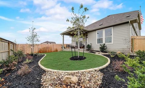 Immaculate landscaping surrounds this modern ranch house's elegant porch at Dauer Ranch, Texas.