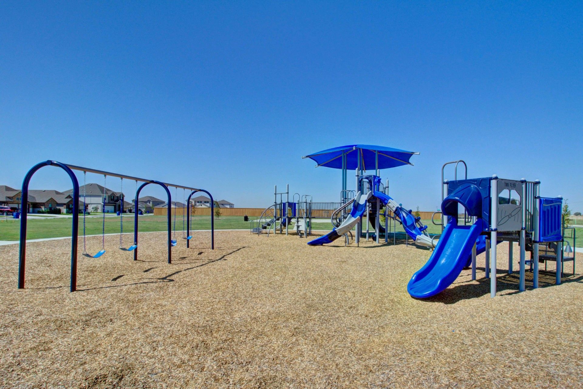 Discover modern outdoor play structures with vibrant slides in Dauer Ranch, surrounded by serene suburban settings.