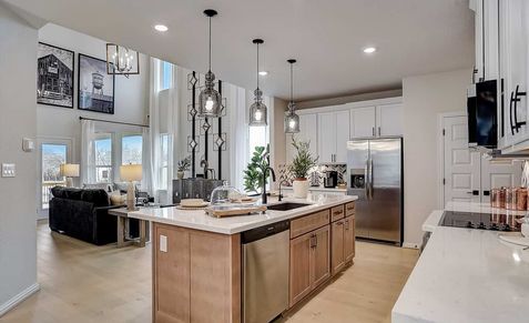 Elegant high ceilings and a gourmet island in Casinas at Gruene create luxurious culinary space.