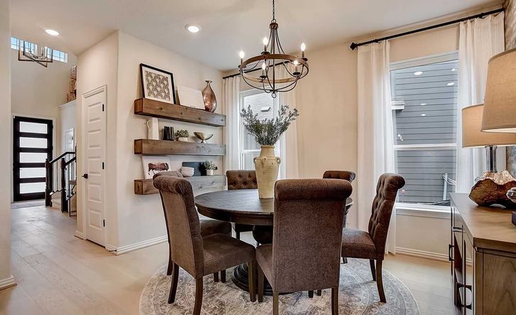 Sophisticated dining space features a wrought iron chandelier and custom wood shelving. Casinas at Gruene, TX.