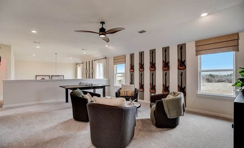 Sophisticated room with bespoke guitar-themed wall art and stylish seating in Casinas at Gruene, Texas.