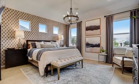 Indulge in luxury with a tufted accent wall and sophisticated chandelier in Gruene, Texas.