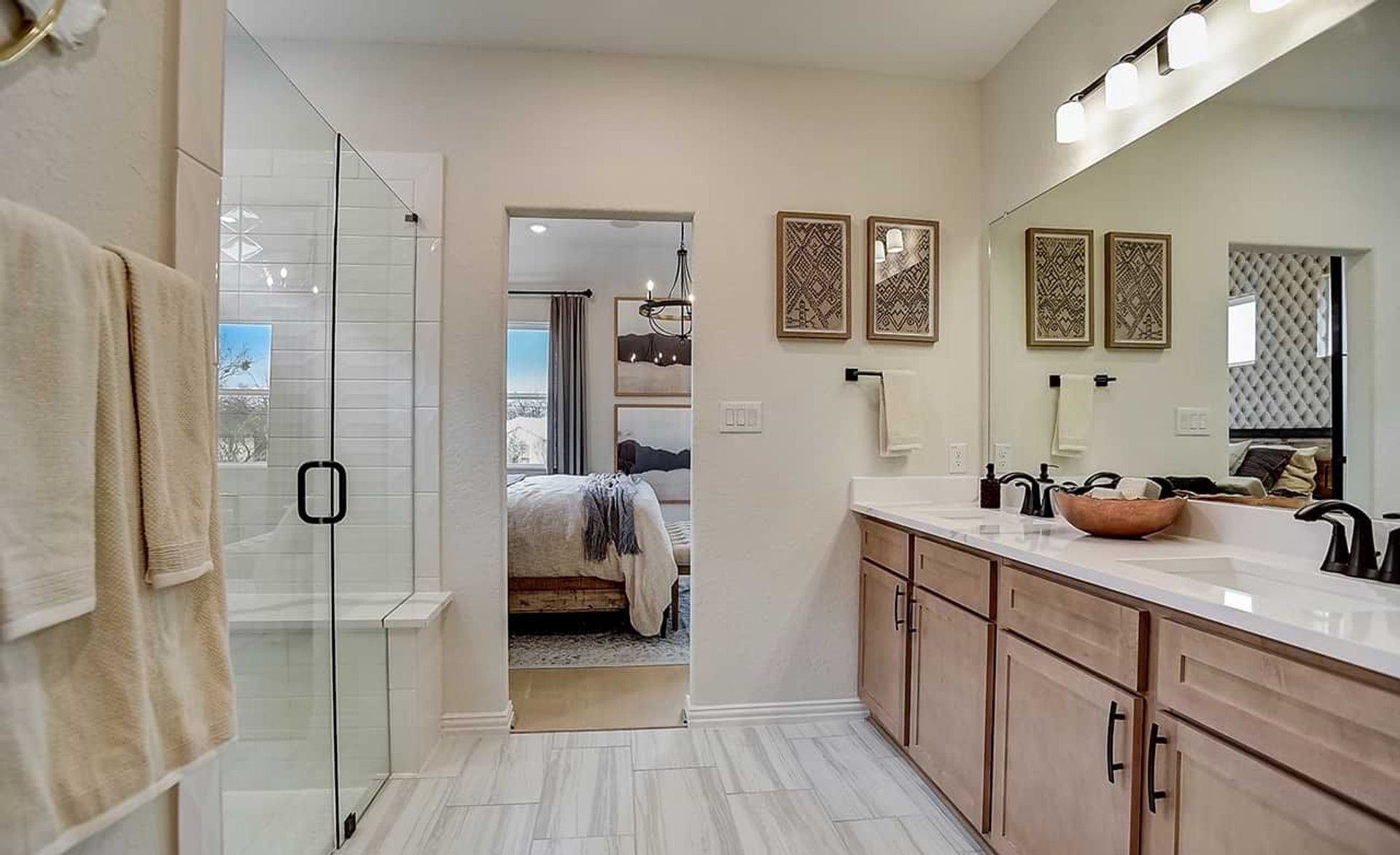 Experience luxury with dual sinks, sleek cabinetry, and a glass-enclosed shower in Casinas at Gruene, New Braunfels.