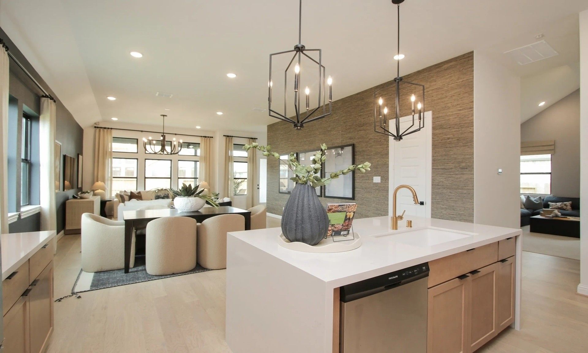 Experience exquisite design with geometric lighting and a sleek quartz island in Coastal Point's luxury homes.