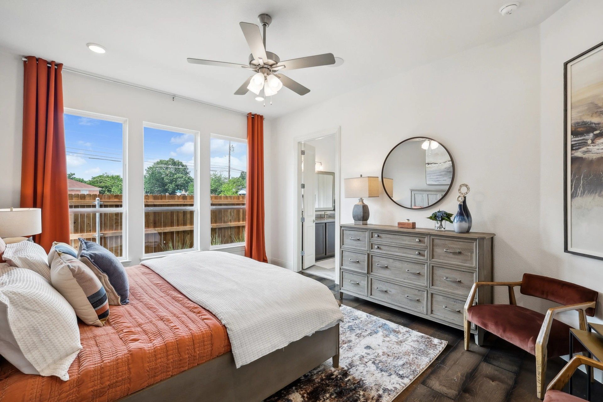 Elegant bedroom in Heritage Park. Features spacious windows, chic fan, and bespoke wooden flooring.